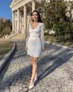 Short white dress made of elastic taffeta, with a V-neckline