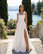 Long white wedding dress with elegant and refined slit made of satin