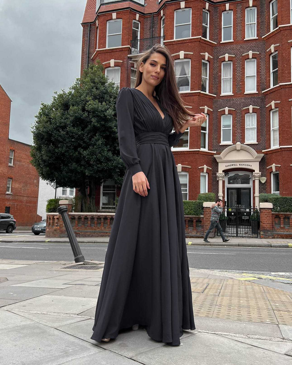 Rochie eleganta neagră de seară, lungă, cu pliuri și decolteu în V, mâneci lungi.